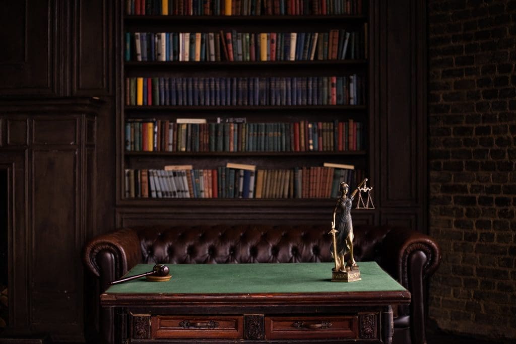 gavel, legal scales, books and a leather couch