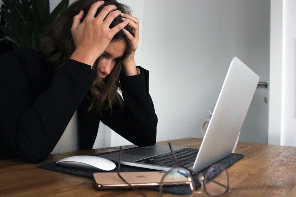 woman with laptop stressed out over unfair commercial property valuations