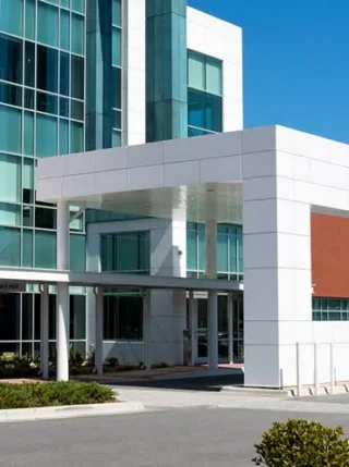 Hospital or healthcare industry commercial building against blue sky